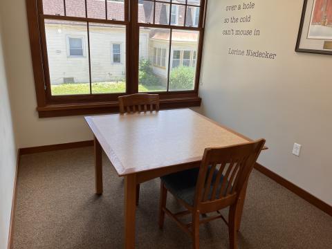 Image of a table and chairs in the Gates Room at the Dwight Foster Public Library.