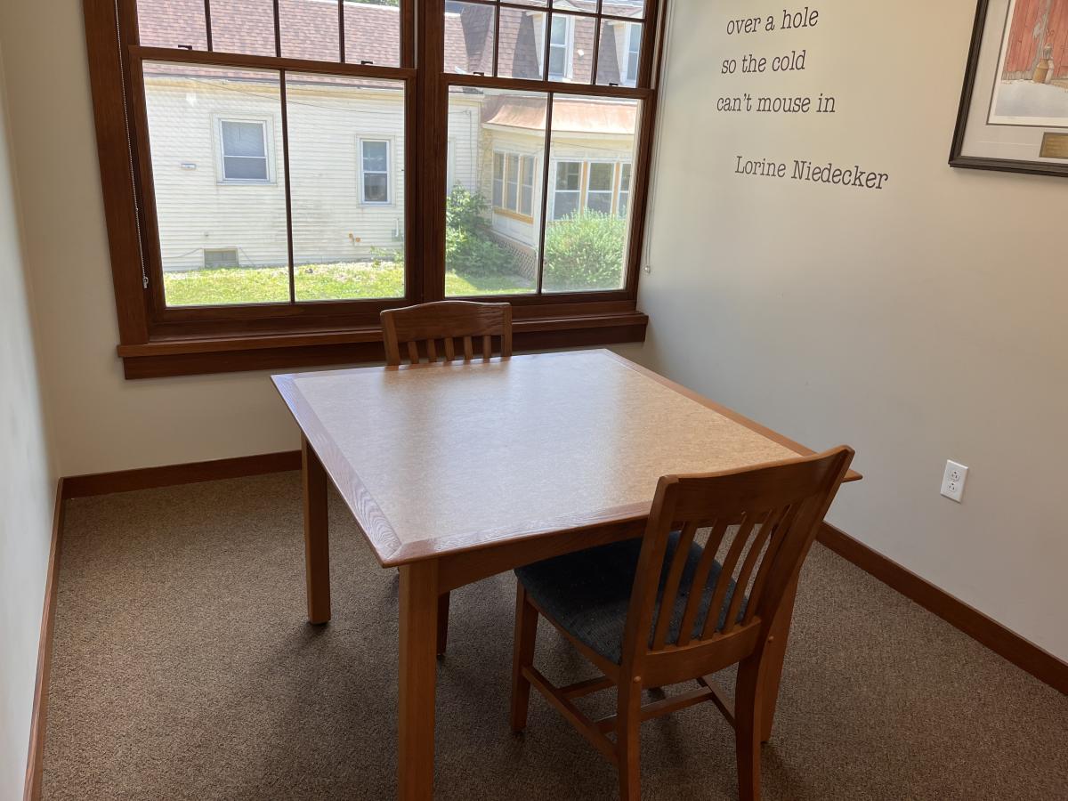 Image of a table and chairs in the Gates Room at the Dwight Foster Public Library.